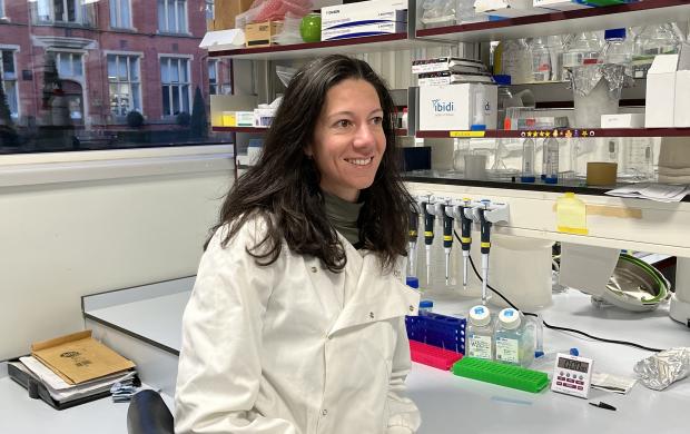 Dr Elena Rainero sitting in a lab 