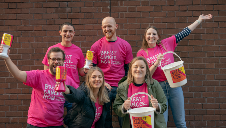 A group of fundraisers wearing pink tops
