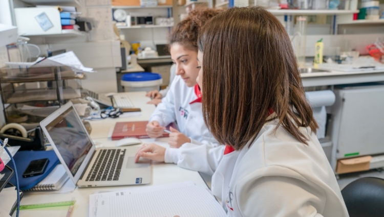 two female researchers sitting at a desk in a laboratory